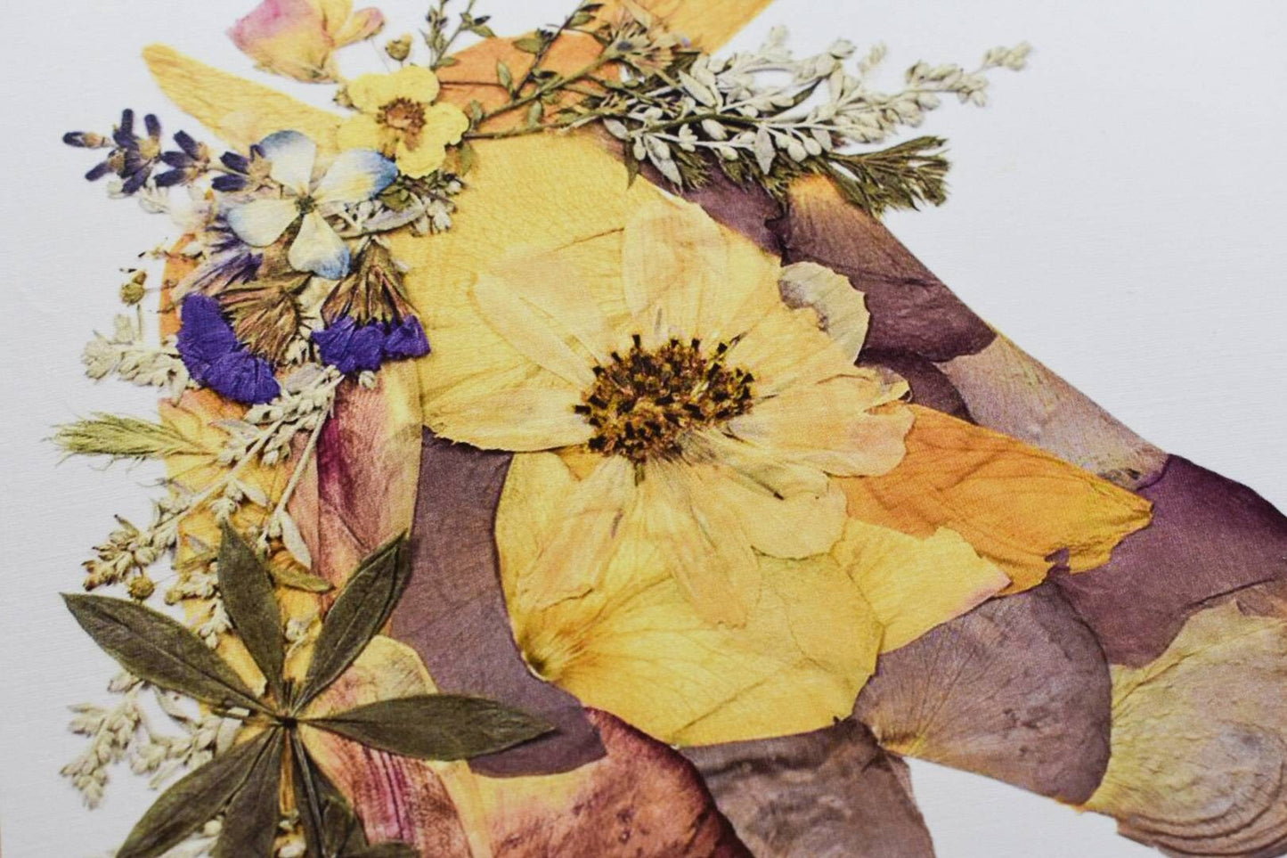 Handcrafted pressed flower art with a mix of bright and pastel blooms.