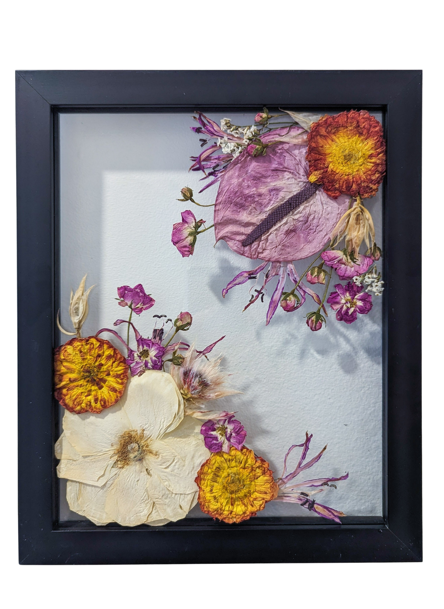 Intricate pressed flower artwork with vibrant colors and delicate textures.