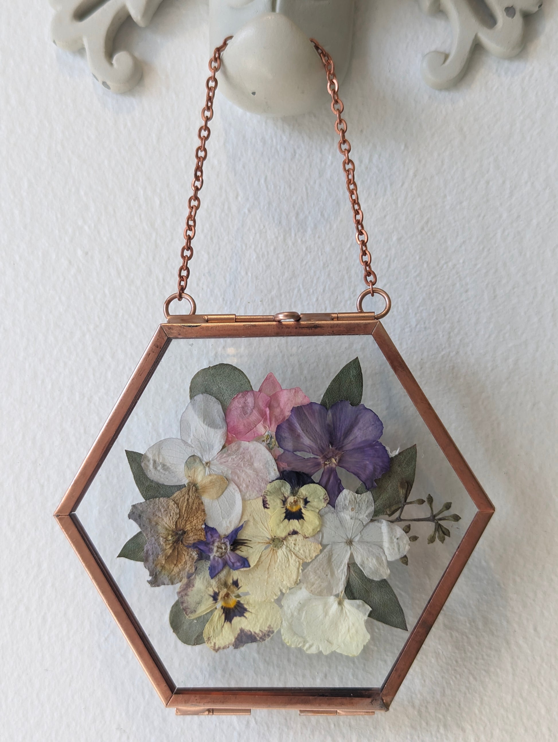 Pressed flower art showcasing preserved wedding flowers in a vintage frame