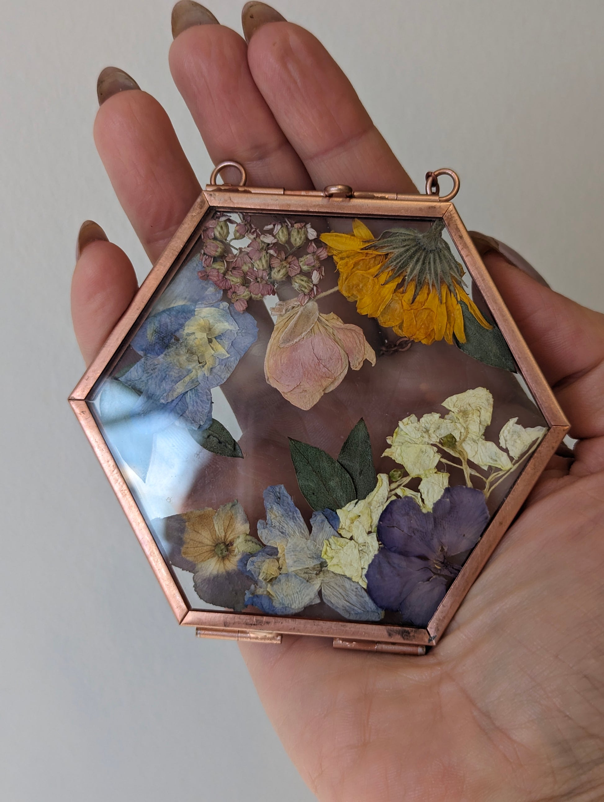 Pressed flower art showcasing preserved wedding flowers in a vintage frame