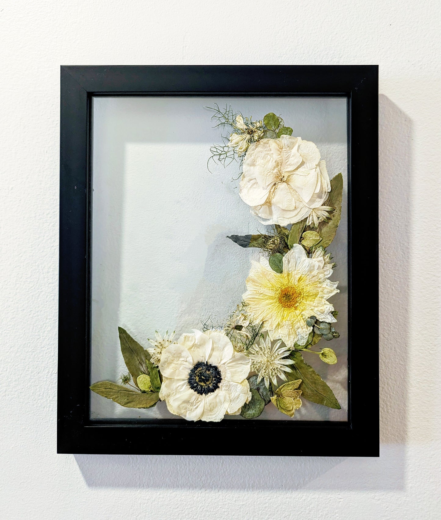 Intricate pressed flower artwork with vibrant colors and delicate textures.