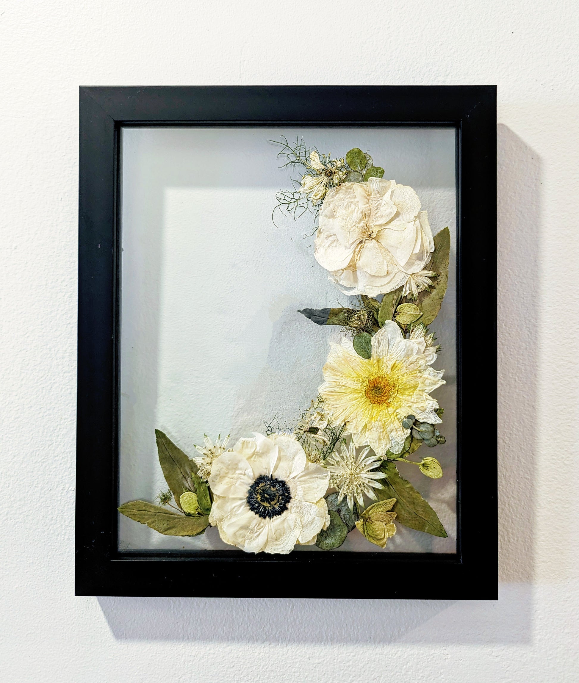 Intricate pressed flower artwork with vibrant colors and delicate textures.