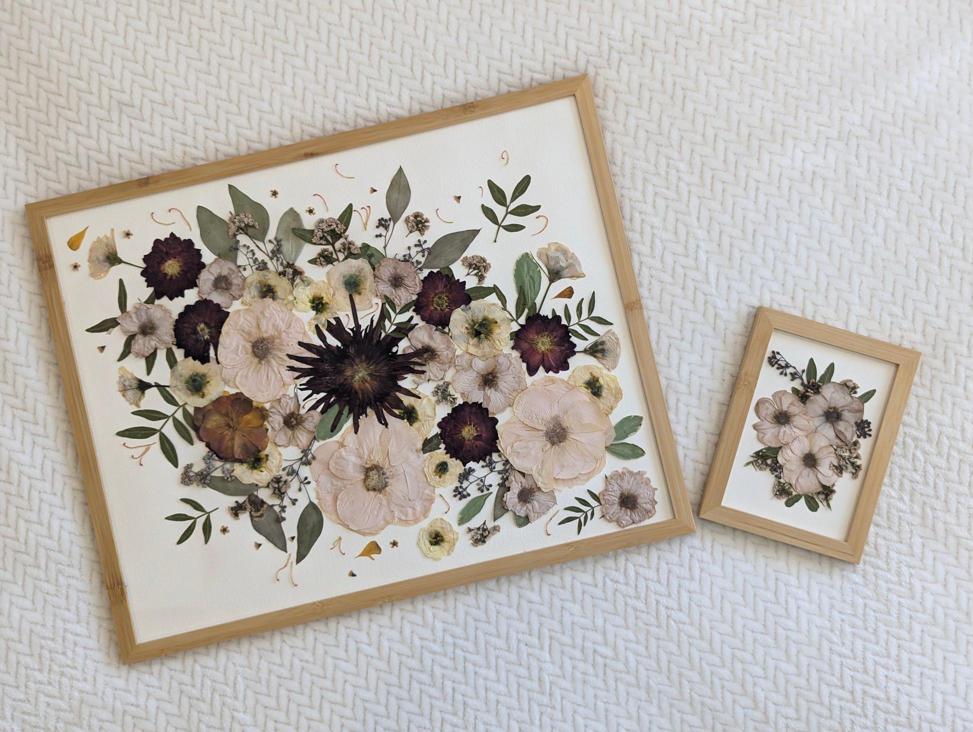 Handmade pressed flower artwork with a vintage aesthetic in a gold frame.