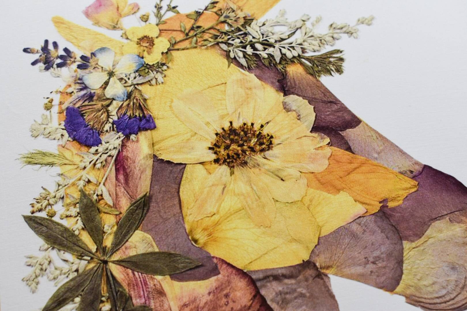 Handcrafted pressed flower art with a mix of bright and pastel blooms.