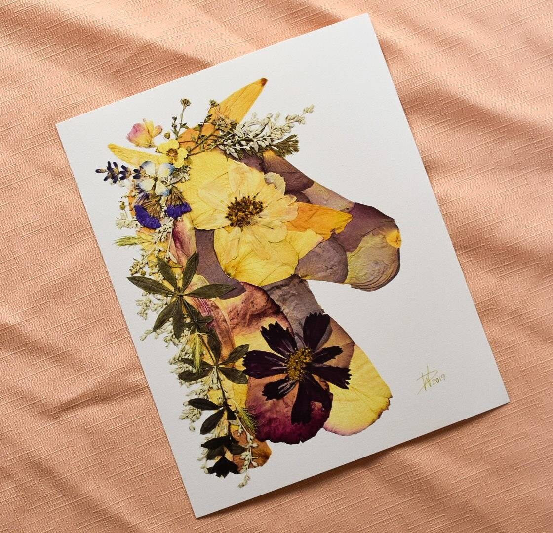Handcrafted pressed flower art with a mix of bright and pastel blooms.