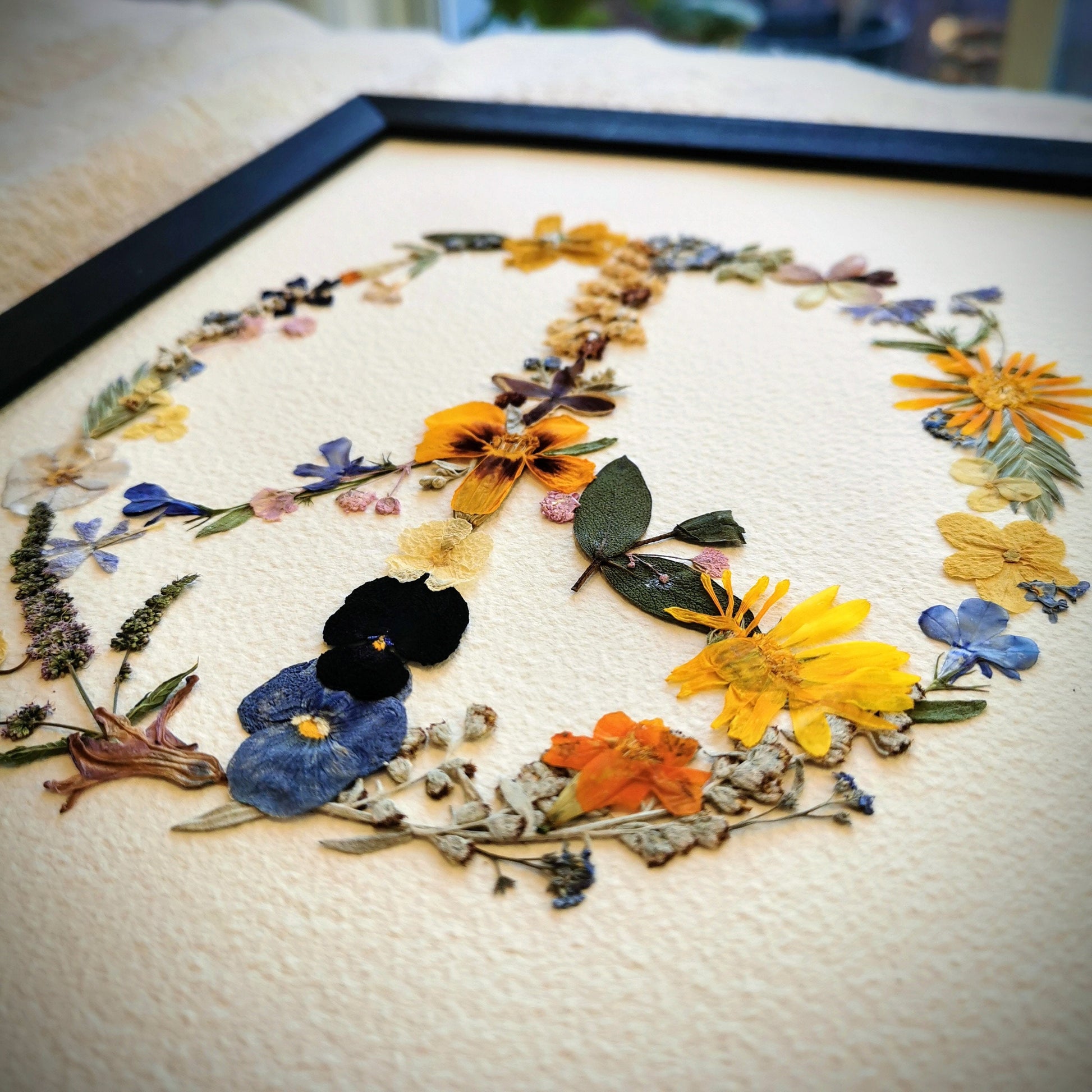 Elegant wedding bouquet preservation displayed as pressed flower art.