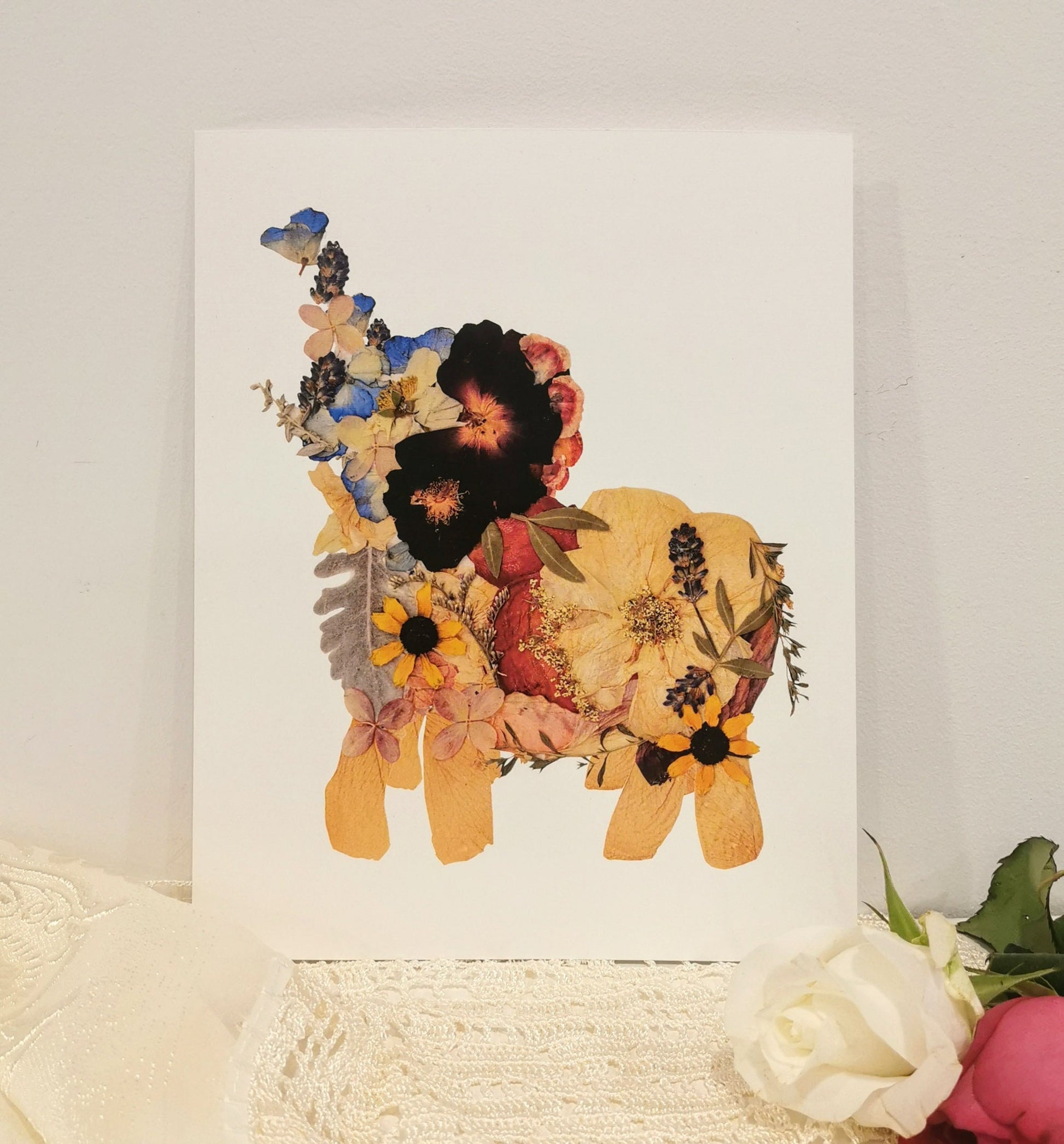 Unique wedding keepsake with pressed flowers arranged in a decorative frame.