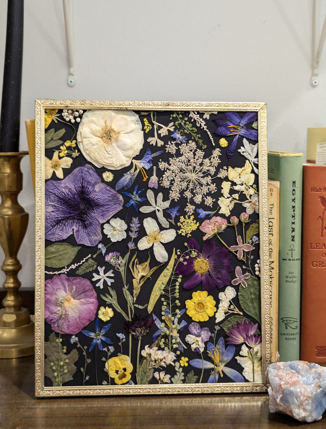 Nature-inspired artwork featuring pressed fern leaves and blossoms.